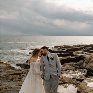 Strapless A- line tulle gown with fabric flowers and plunging neckline